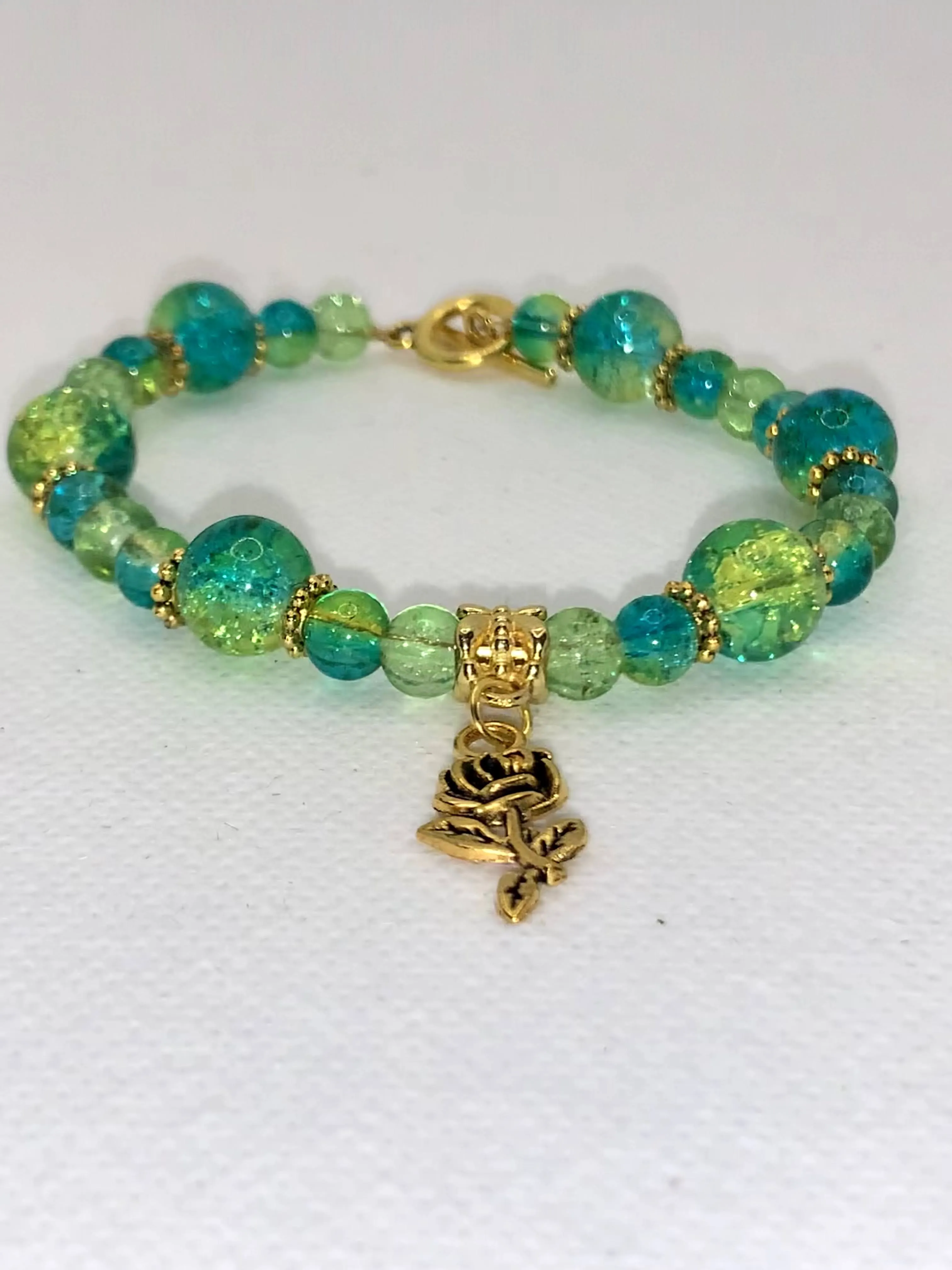 Green/Blue Crackle multi-size beaded bracelet with gold flower and clasp